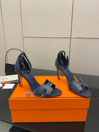Hermes blue leather heeled sandals with wide cutout straps and ankle buckle