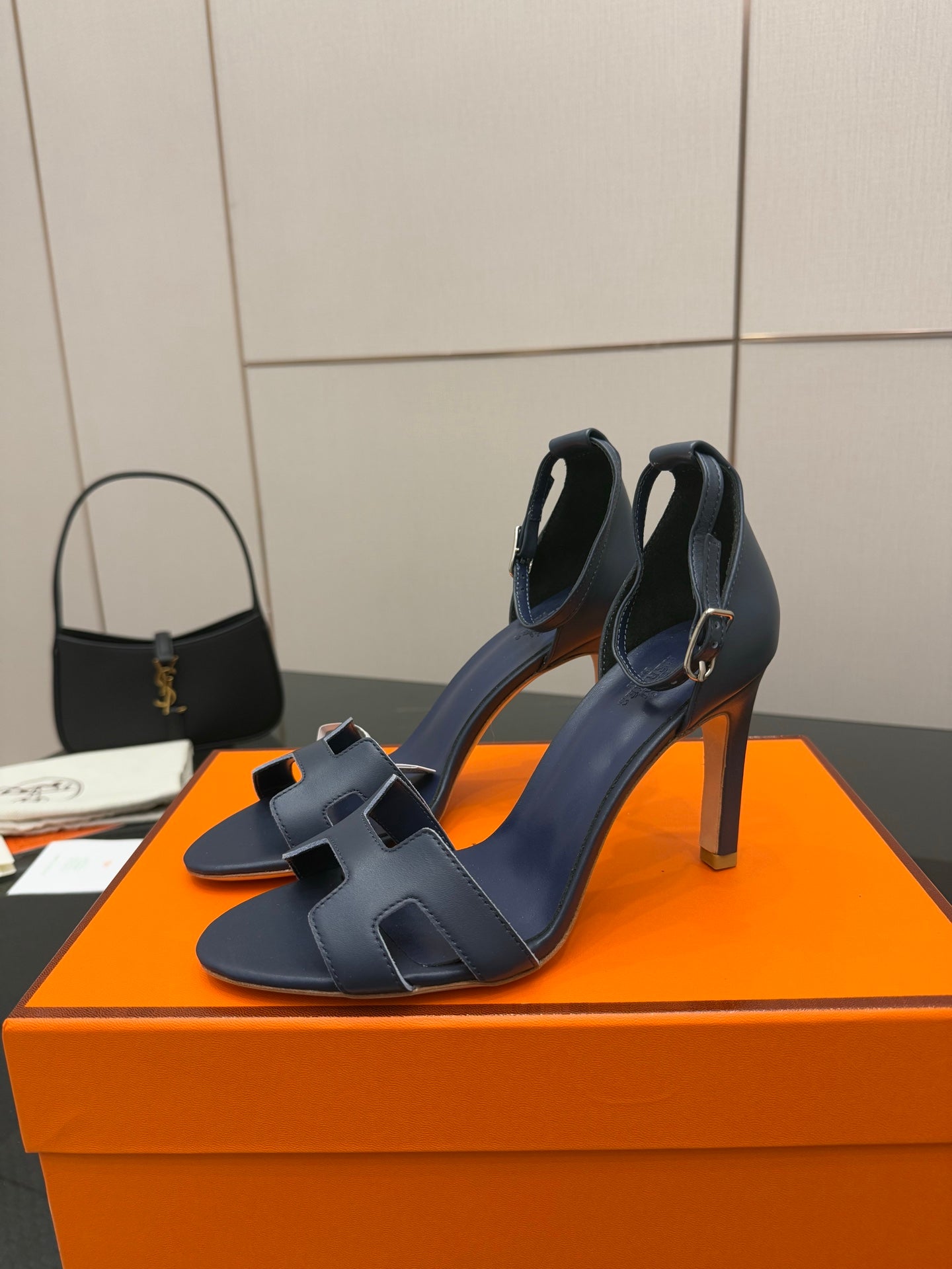 Hermes blue leather heeled sandals with ankle strap and buckle, open-toe design