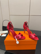 Hermes red strappy heeled sandals, angled view with slim stiletto heels