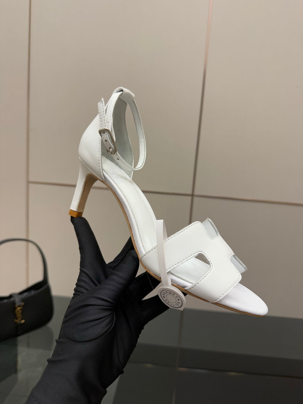 White heeled sandal with ankle strap, open toe, and gold-tone heel