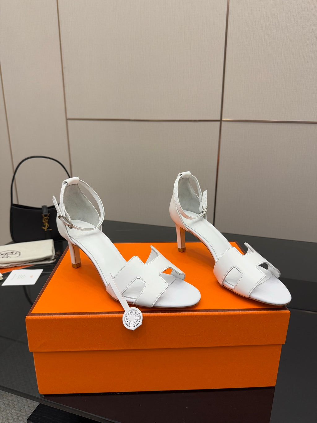 White heeled sandal with slim straps and buckle-style ankle closure