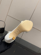 White sandal sole and heel underside with brand markings