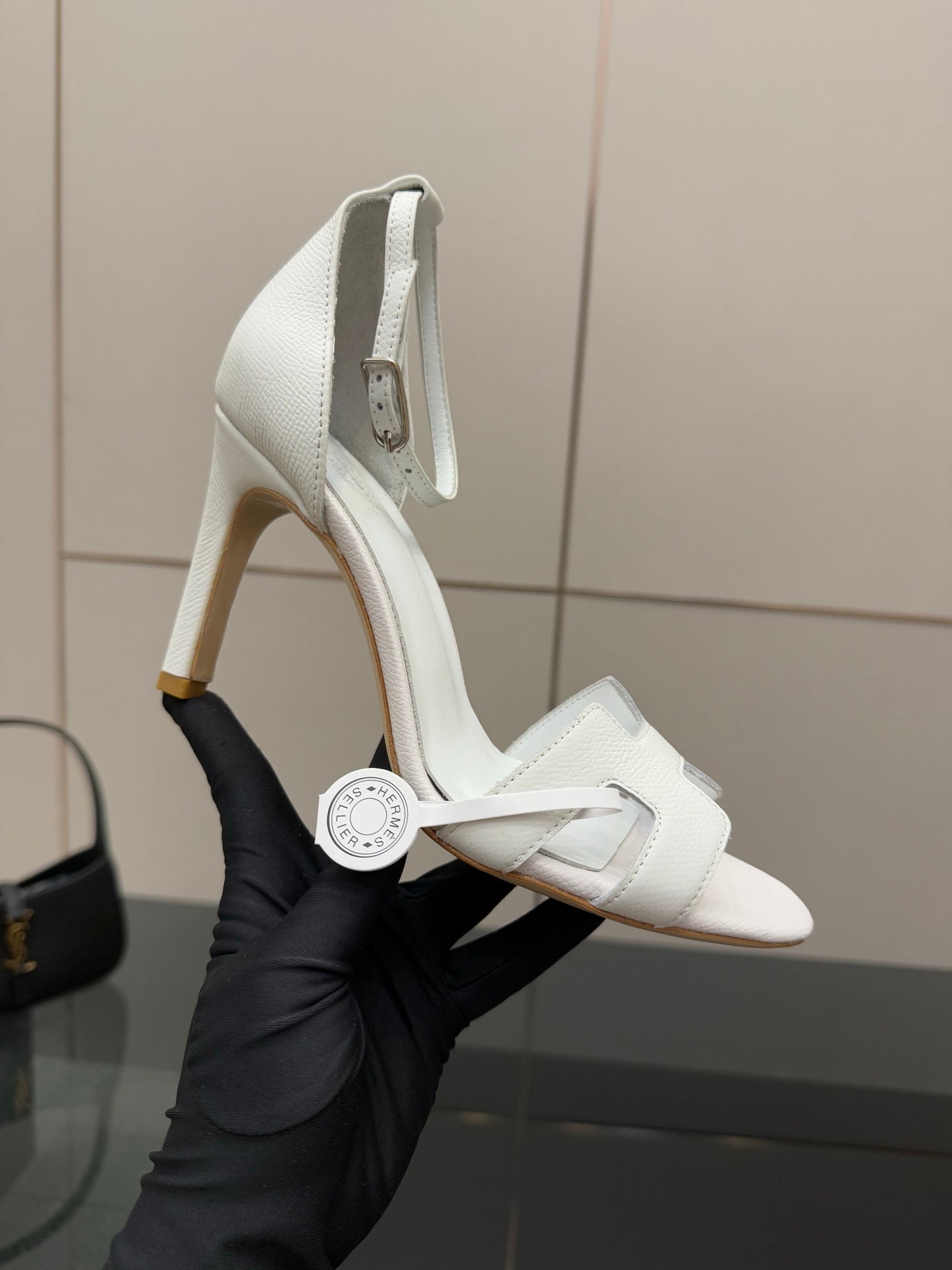 White heeled slingback sandal with textured leather upper and ankle strap