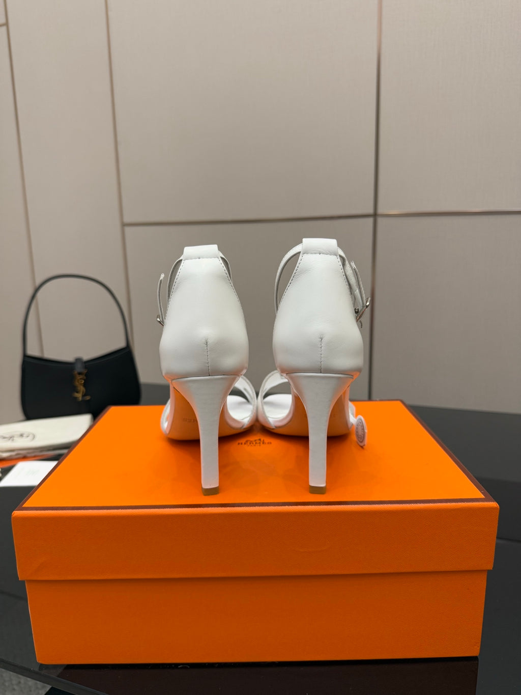 Hermes women's white heeled sandals, heel view with ankle strap