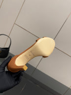 Tan leather heeled sandal sole and heel, with ankle strap and cutout panel