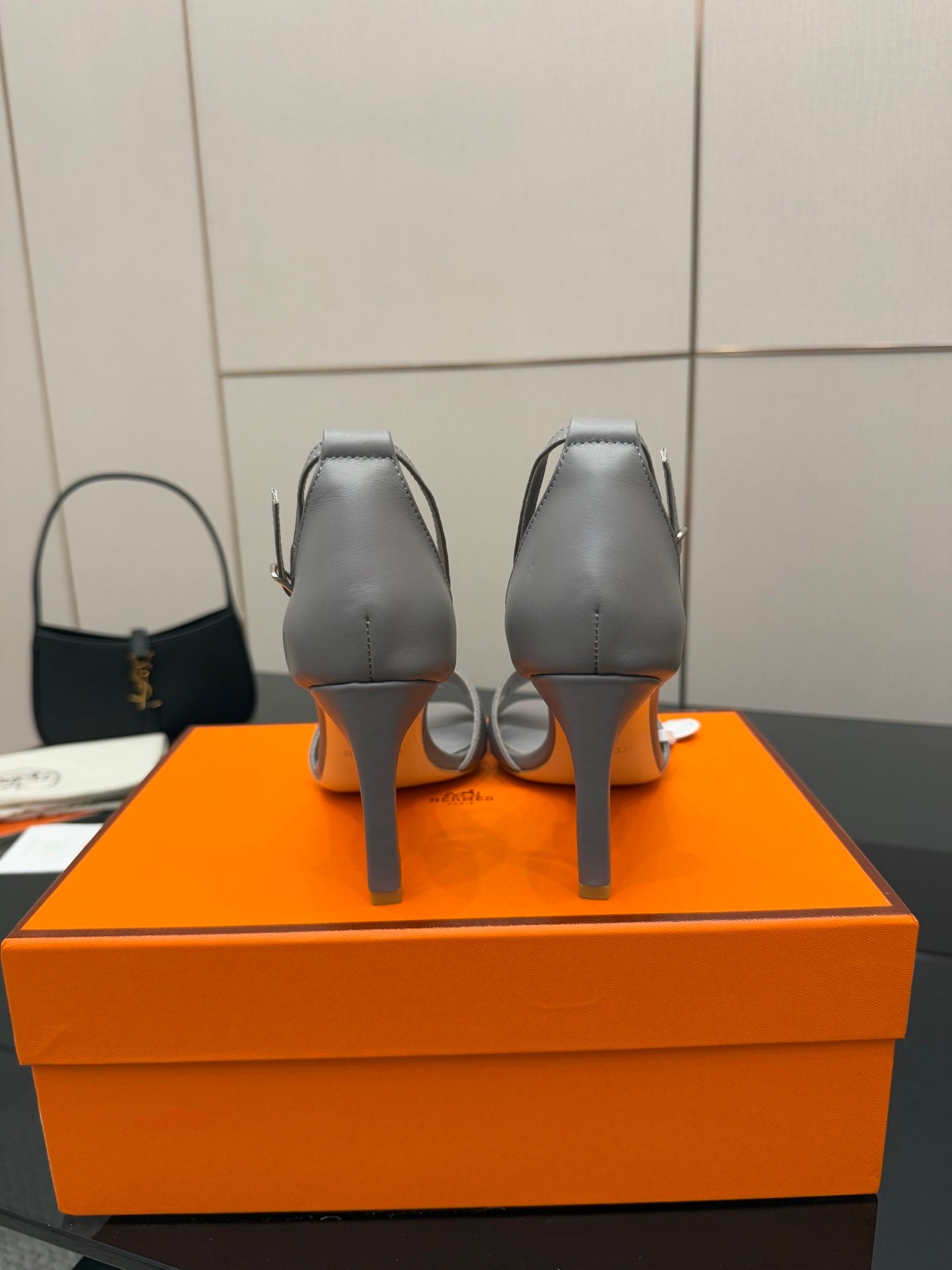 Hermes ladies gray heeled sandals shown from the back with high heel and straps