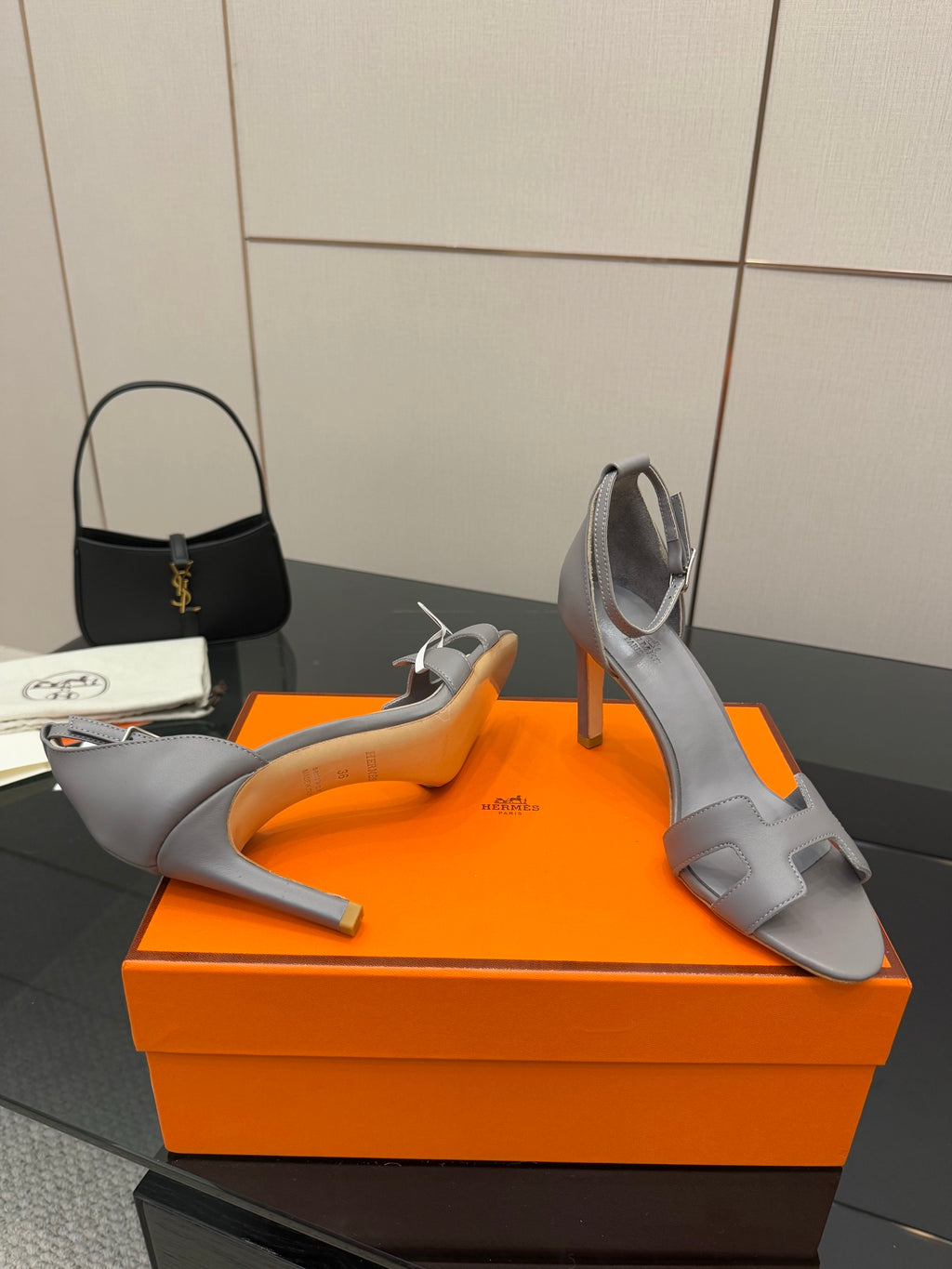 Hermes ladies gray leather heeled sandal with ankle strap and open-toe silhouette