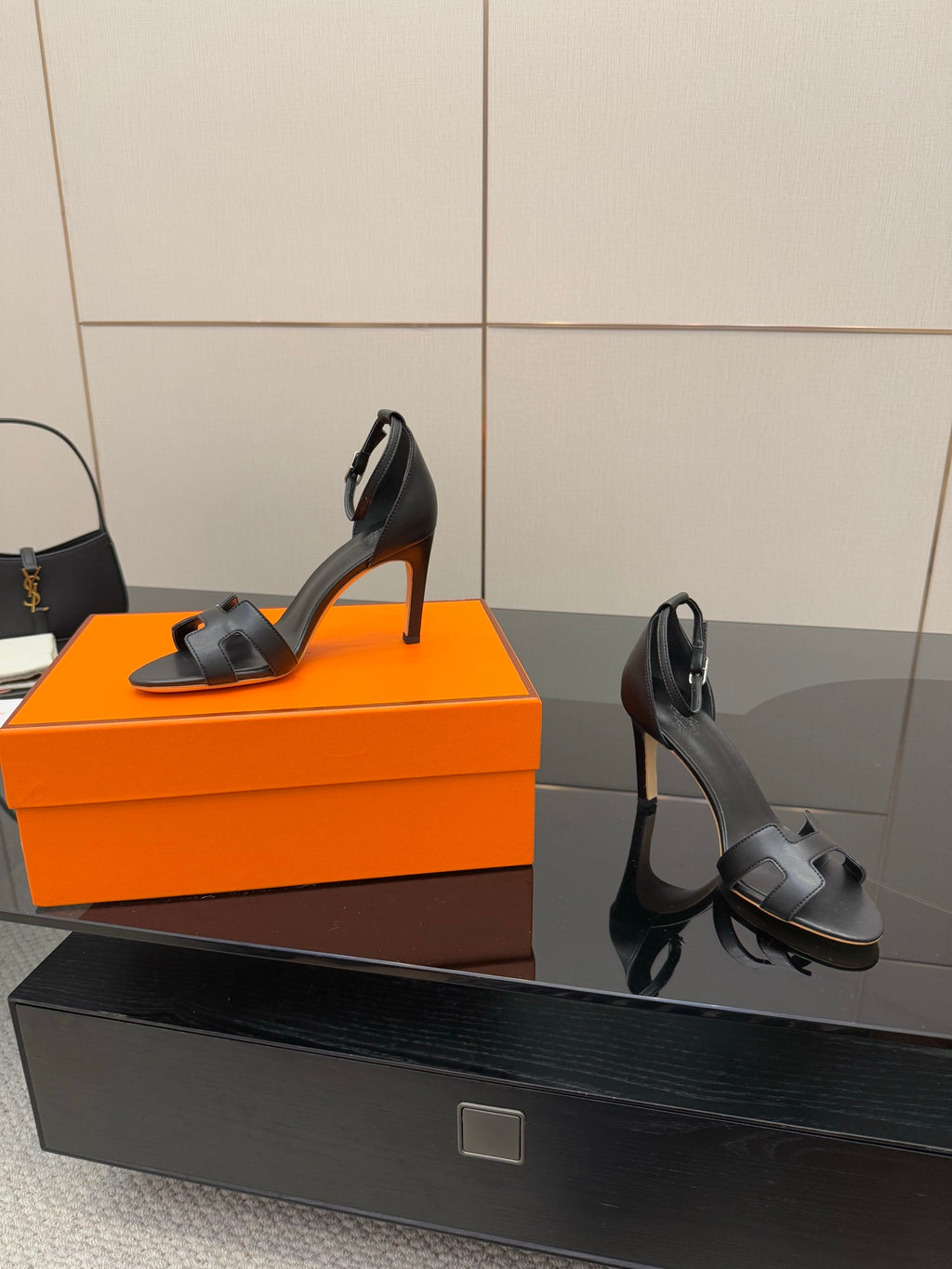 Women's black leather heeled sandals with angled profile and slim stiletto heel