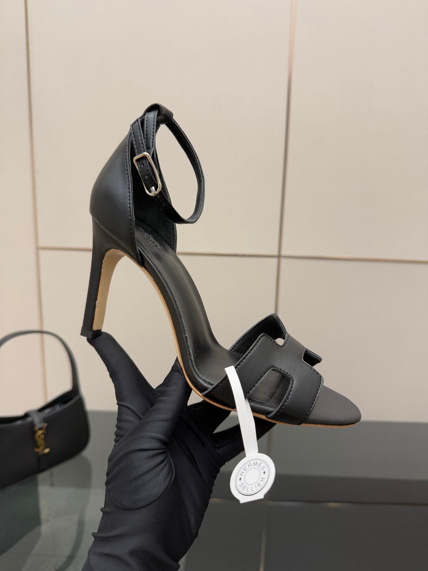 Women's black leather heeled sandals with ankle strap and wide buckle detail
