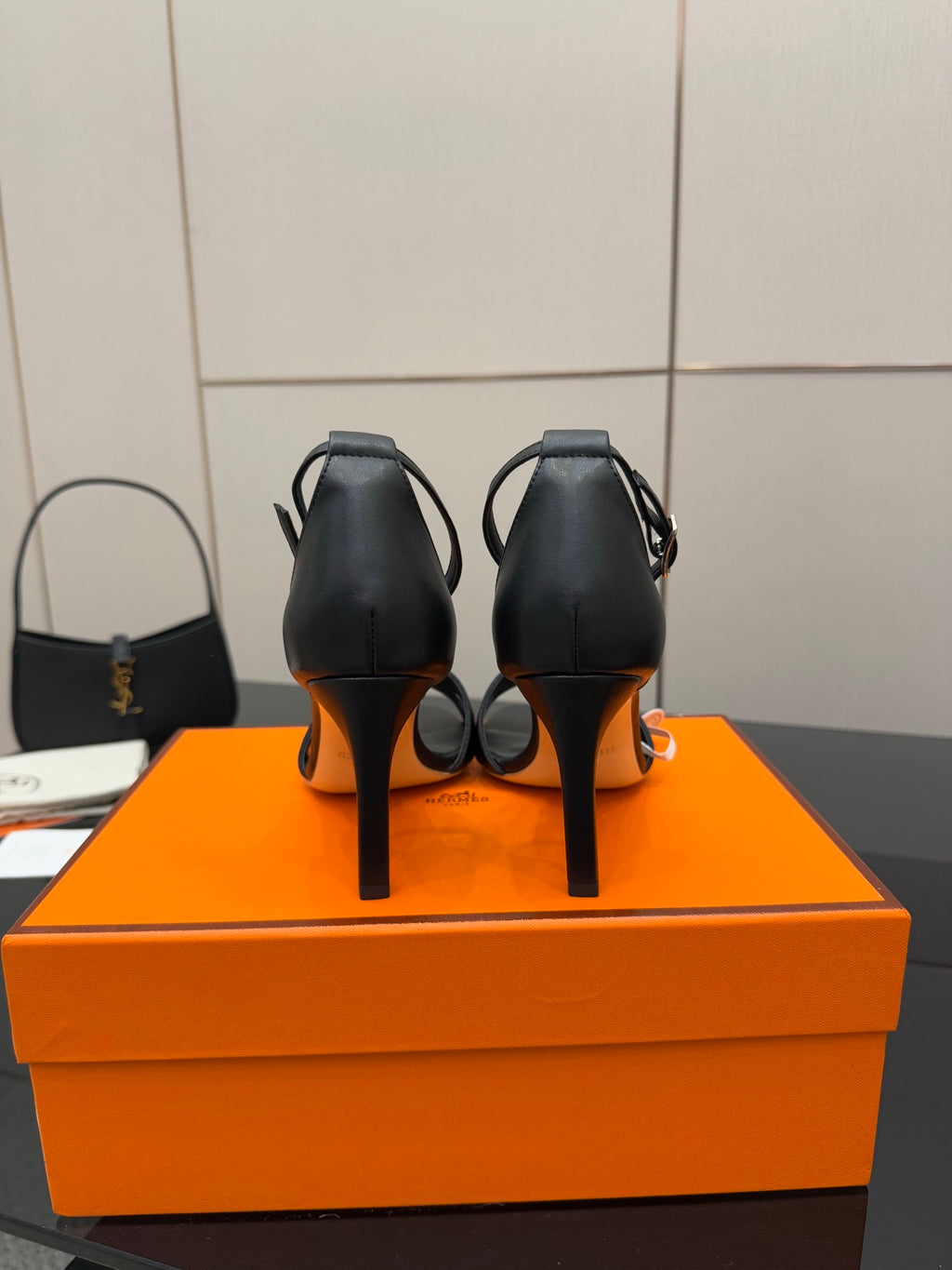Women's black leather heeled sandals, back view, slim stiletto heel and ankle strap