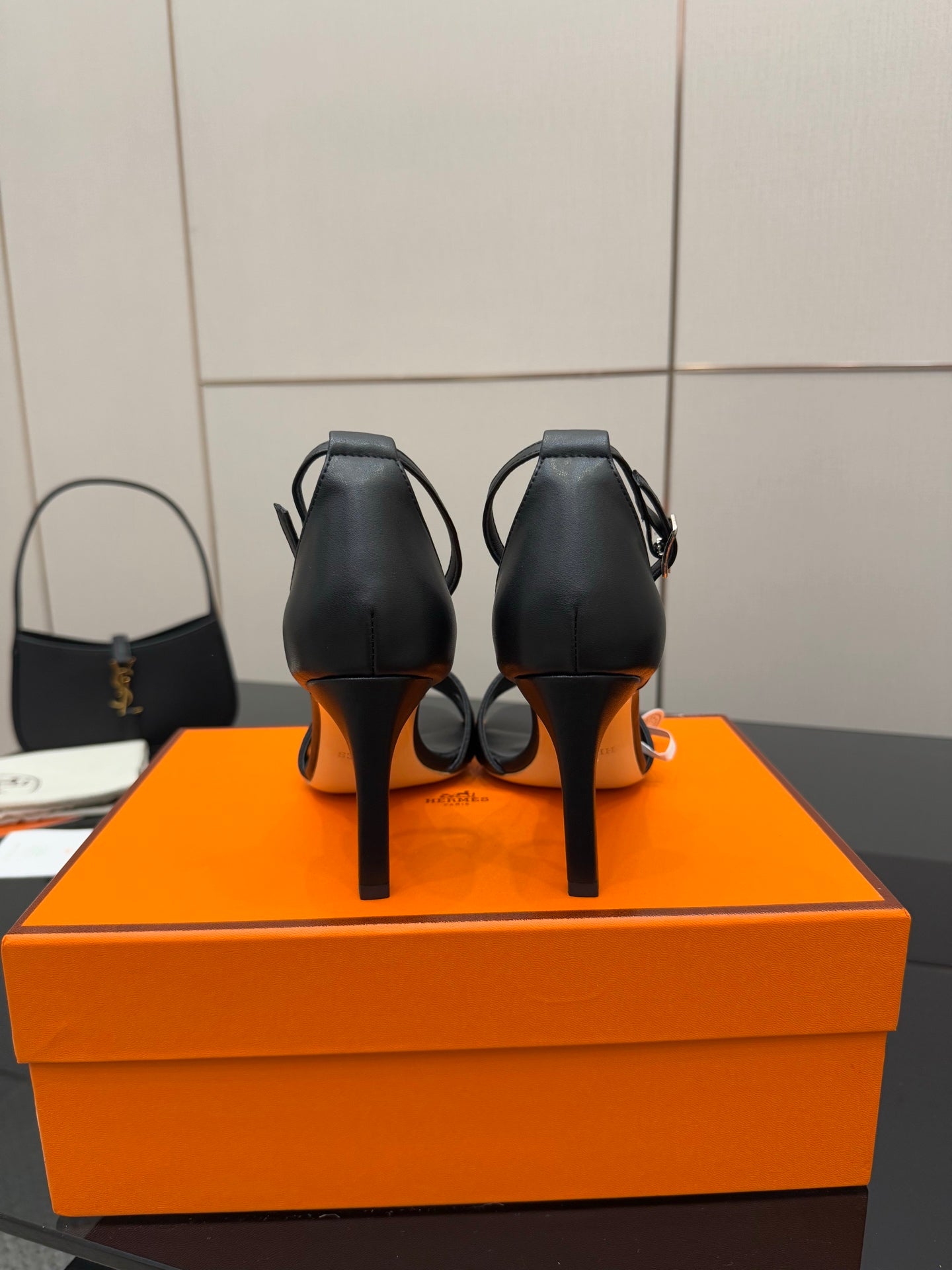Women's black leather heeled sandals, back view, slim stiletto heel and ankle strap
