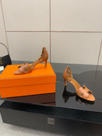Tan leather heeled sandals with open toe and ankle strap, side view