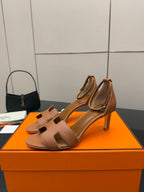 Tan leather heeled sandals with H-style cutout strap and ankle sling