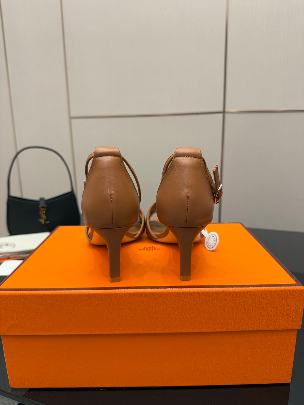 Tan leather heeled sandals back view with sling strap and heel