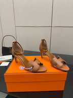 Tan leather heeled slide sandals with ankle sling and open toe