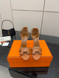 Tan leather heeled sandals with ankle strap and cutout H-style front detail