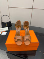 Tan leather heeled sandals with ankle strap and cutout H-style front detail
