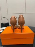 Tan leather heeled sandals, showing heel and back view with ankle strap