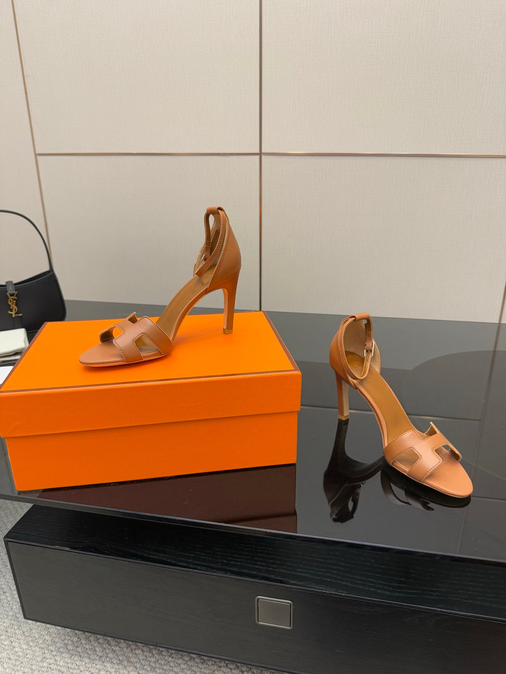 Tan leather heeled sandals with ankle strap, side view on display