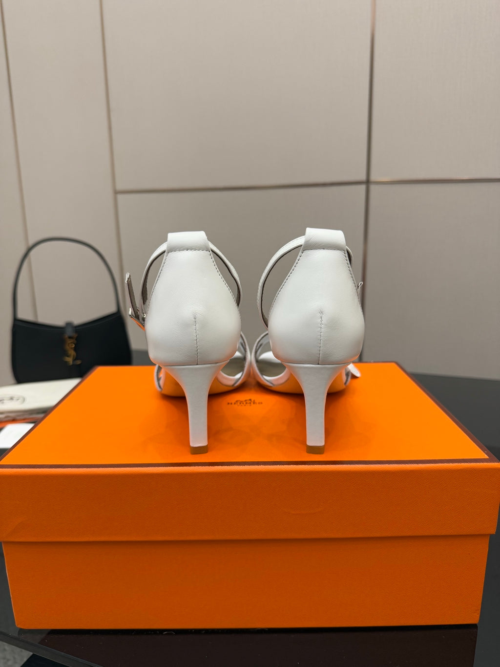 Hermes white leather heeled sandals, rear view with slingback strap and heel