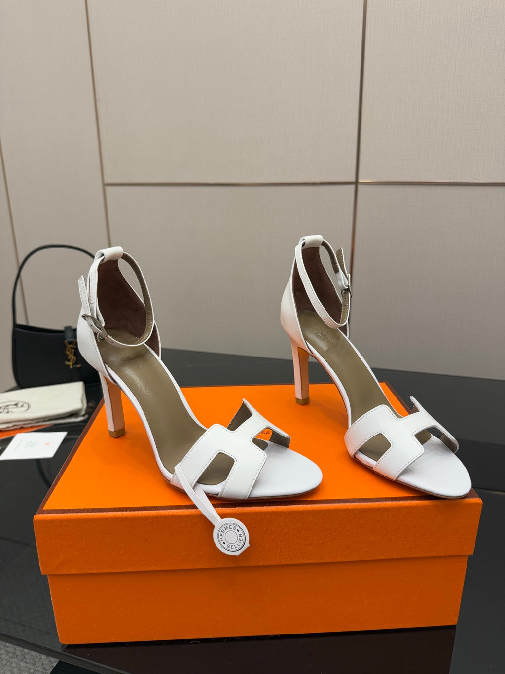 White heeled sandals with square-toe cutout straps and slender heel