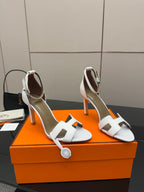 White heeled sandals with square-toe cutout straps and slender heel