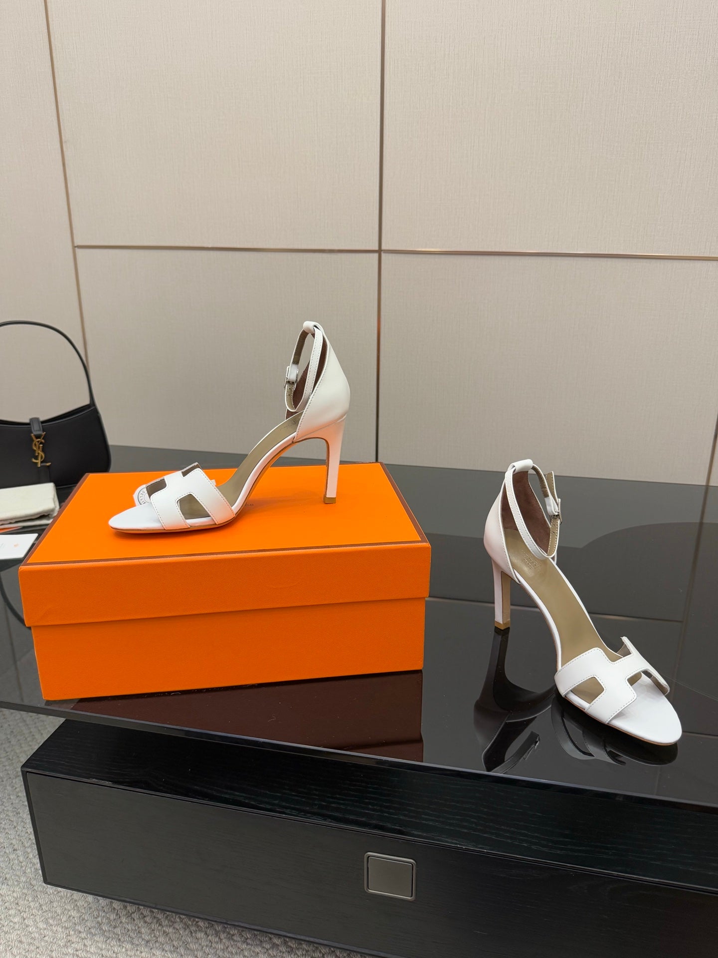 White heeled sandals with open toe, ankle strap, and thin heel