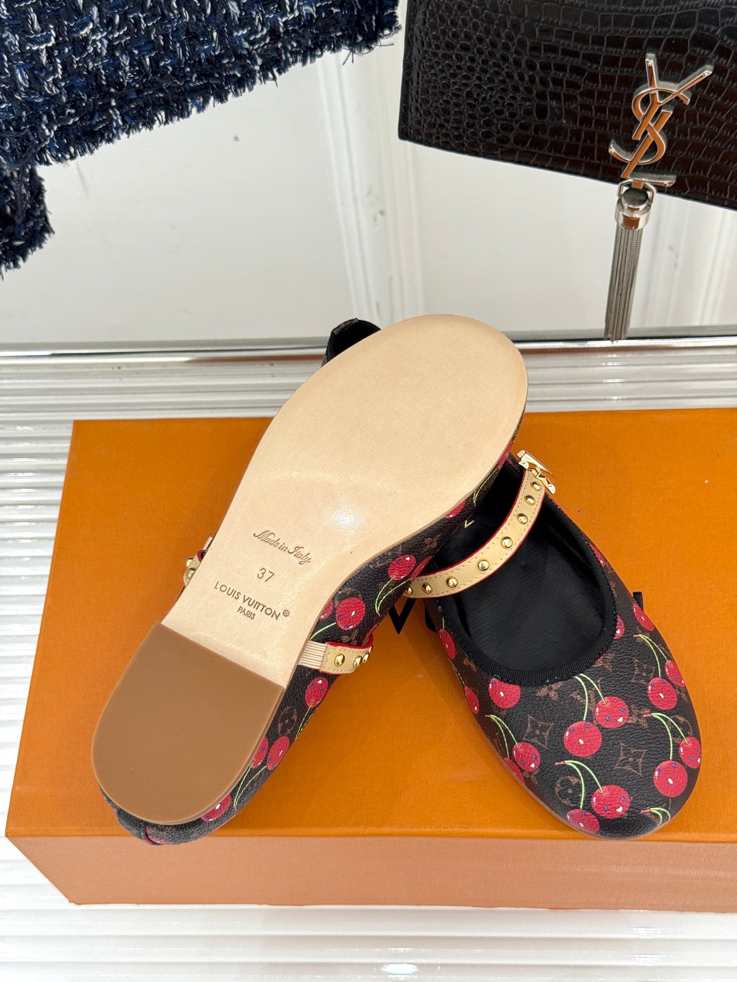 Women's cherry-print flats with gold studded strap and beige outsole
