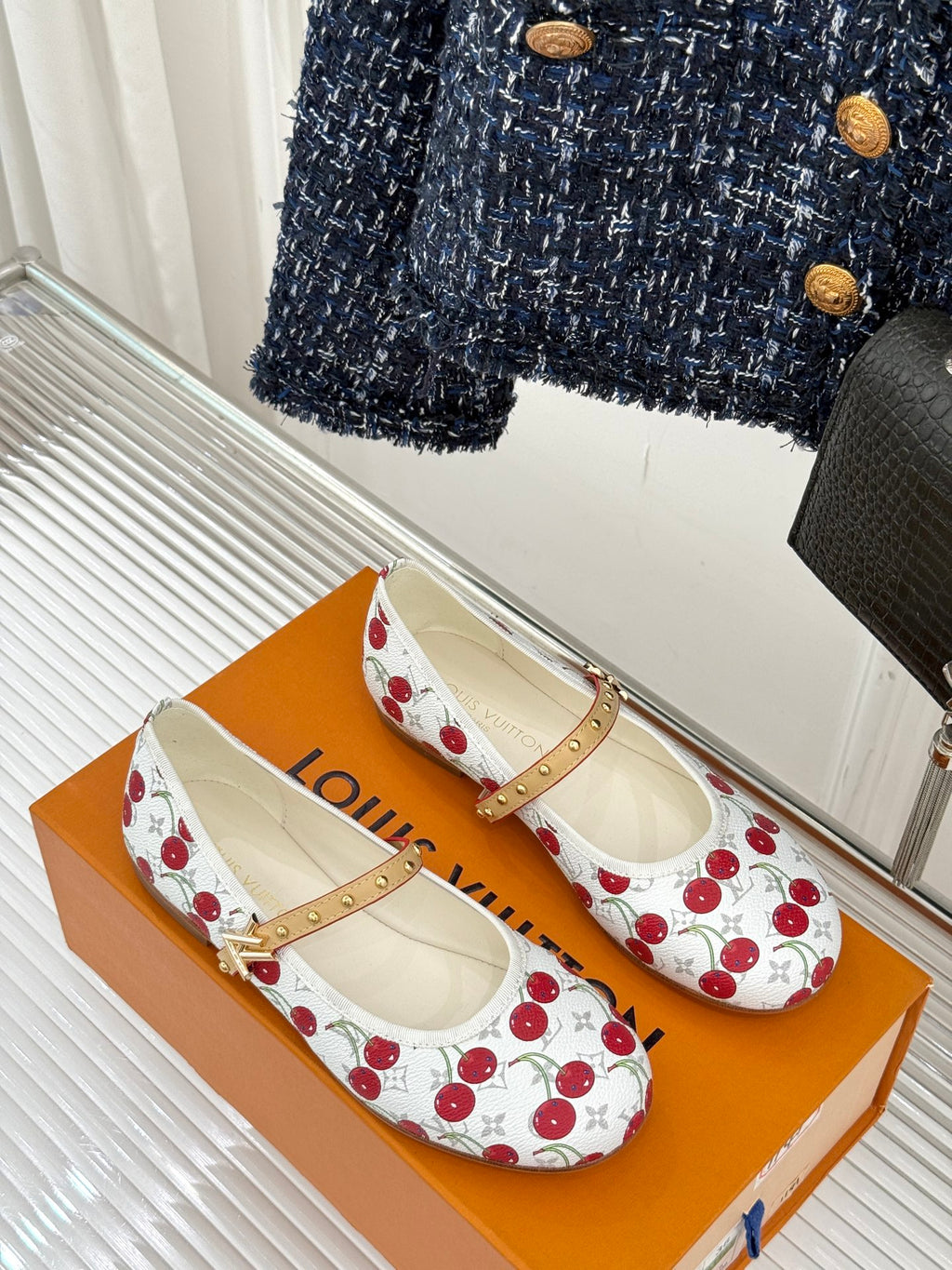 Louis Vuitton cherry-print flats with tan ankle strap and gold stud trim