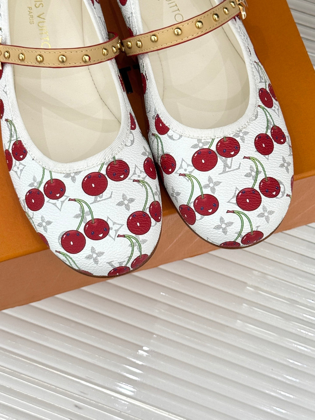 Louis Vuitton cherry-print ballet flats with tan studded straps, stitched panels