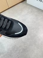 Givenchy black sneakers, close-up side with curved reflective stripe and logo panel