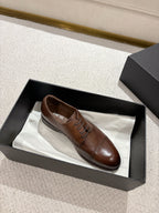 Brown leather lace-up dress shoe in black box with another shoe inside