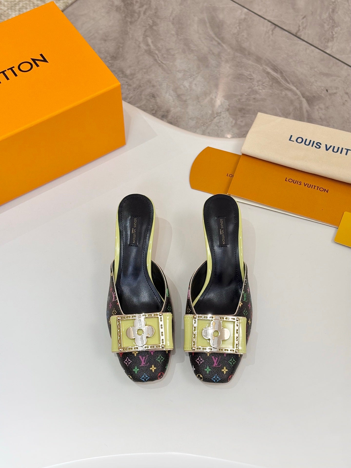 Pair of ladies mules in monogram canvas with neon green heels, gold buckle hardware