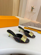 Two ladies mules on display with monogram canvas, gold buckles, neon green heels