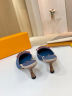 Women's blue monogram mules viewed from back with low block heels