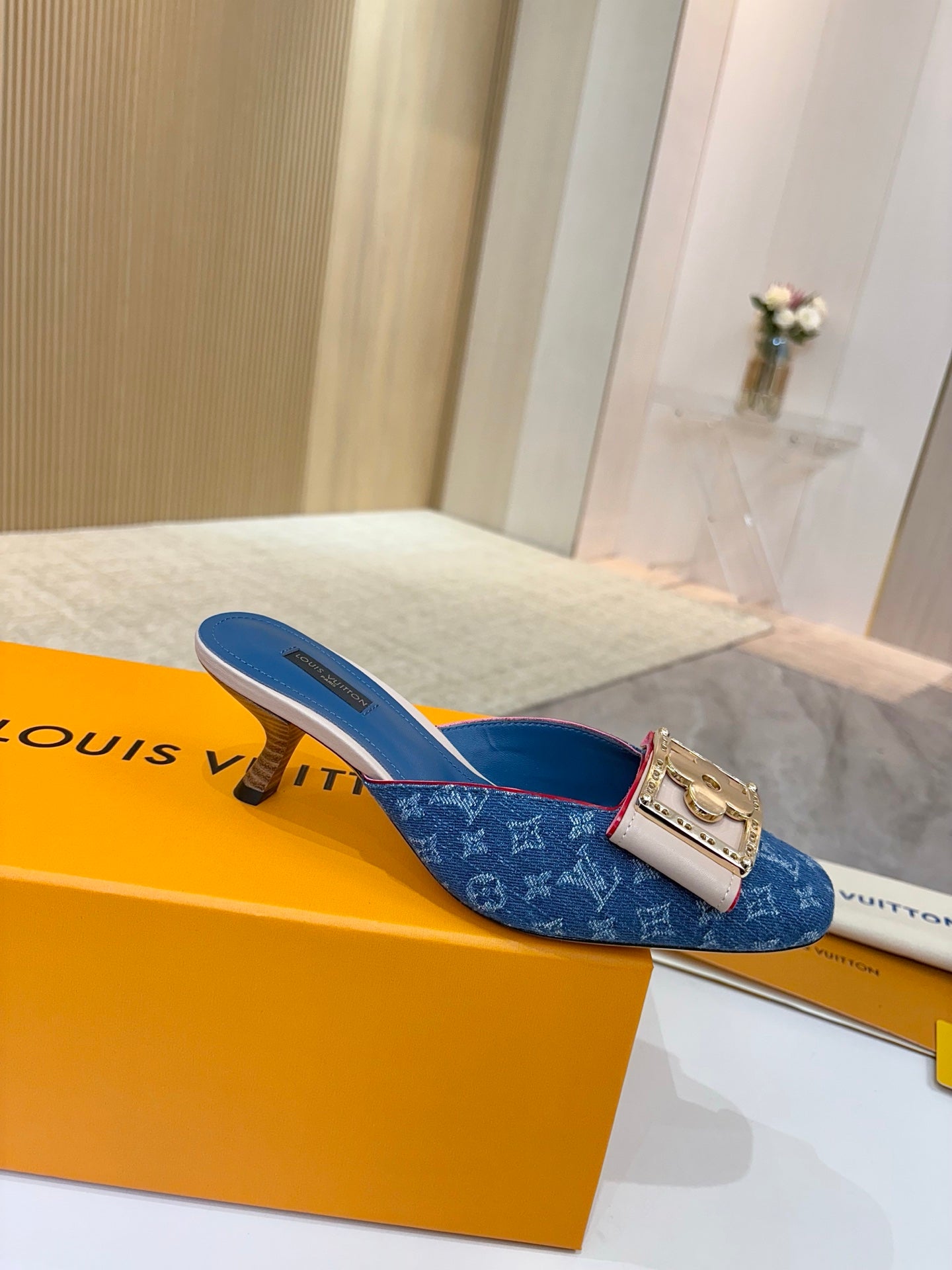 Women's blue monogram mules with gold buckle and low heel