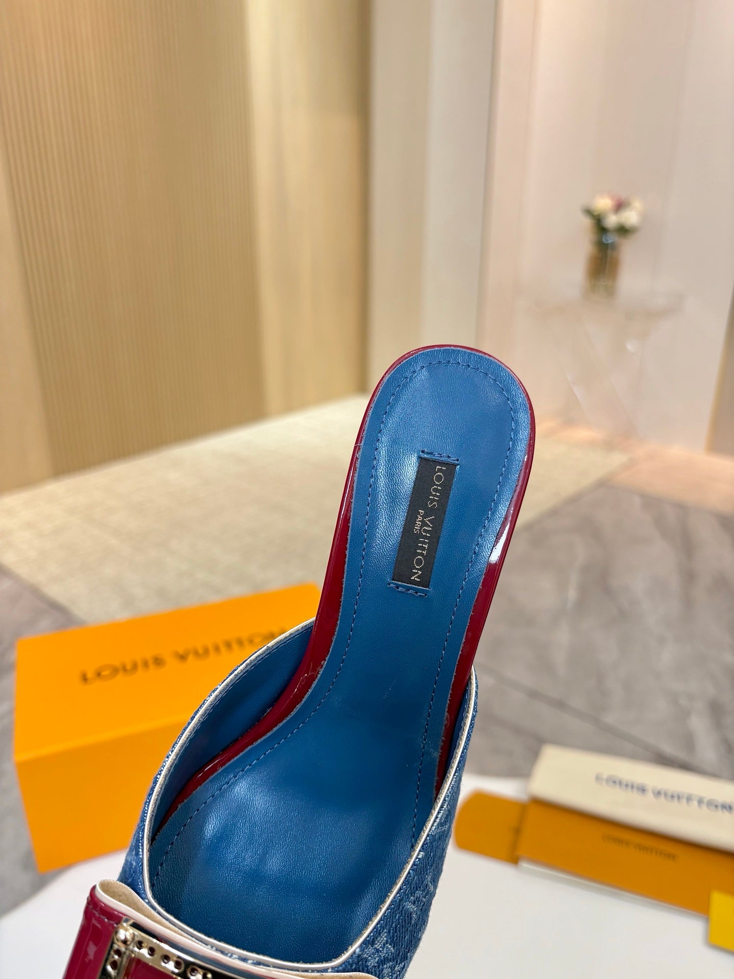 Blue monogram heeled mule with burgundy side trim and gold-toned buckle