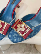 Pair of blue monogram mules with gold buckle and burgundy strap accents