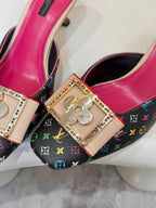 Louis Vuitton ladies shoes close-up: gold emblem buckle on multicolor monogram fabric with pink trim
