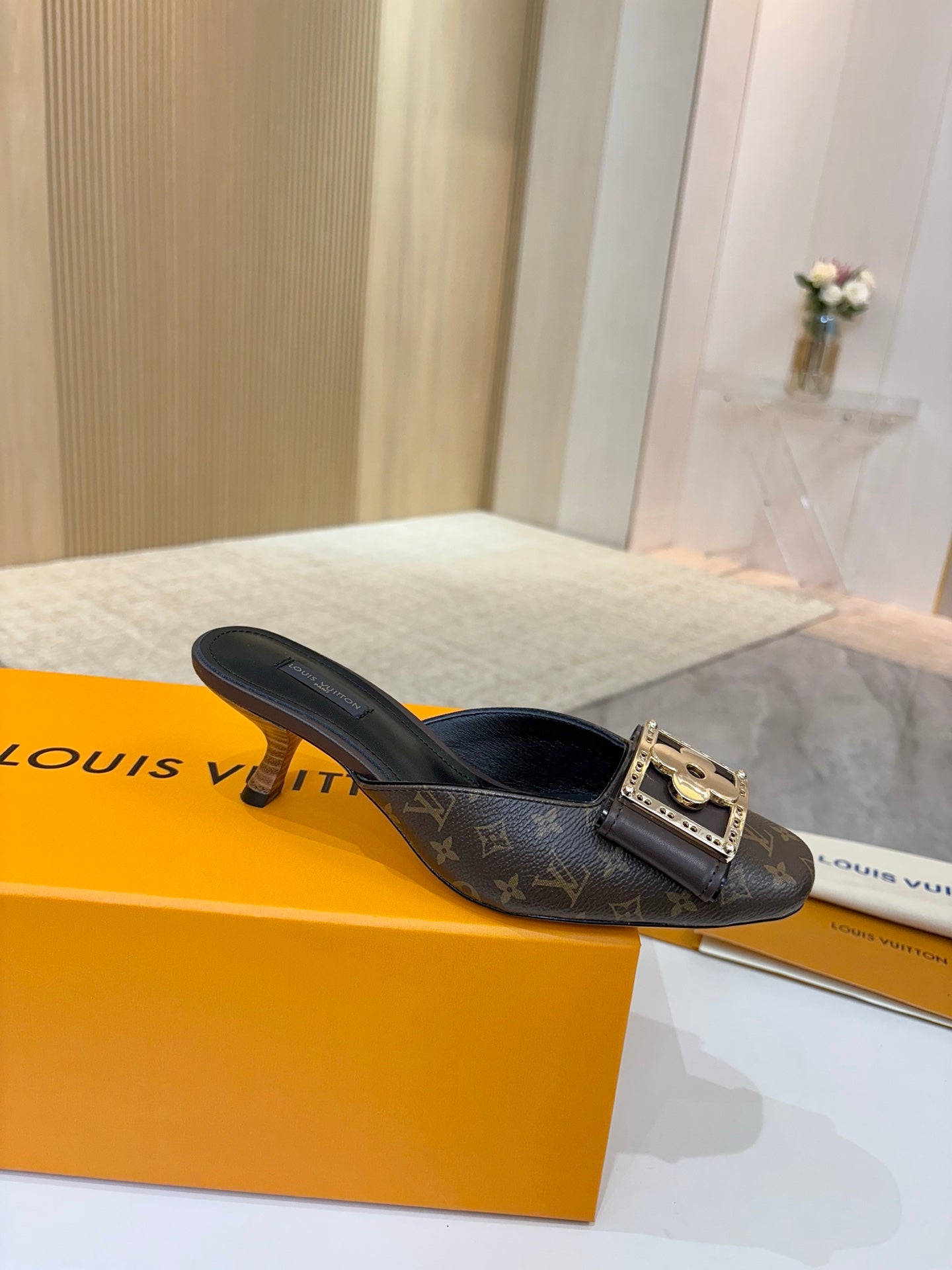 Louis Vuitton women's mule shoes in dark monogram with gold buckle, black leather trim