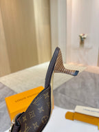 Louis Vuitton mule shoe profile with monogram side panel and slender heel