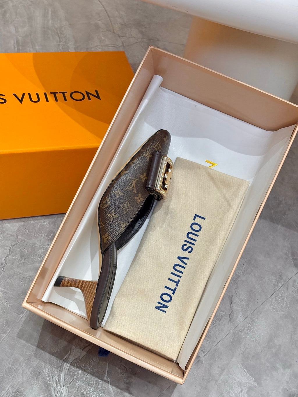 Louis Vuitton mule shoe in open box with monogram upper and dust bag