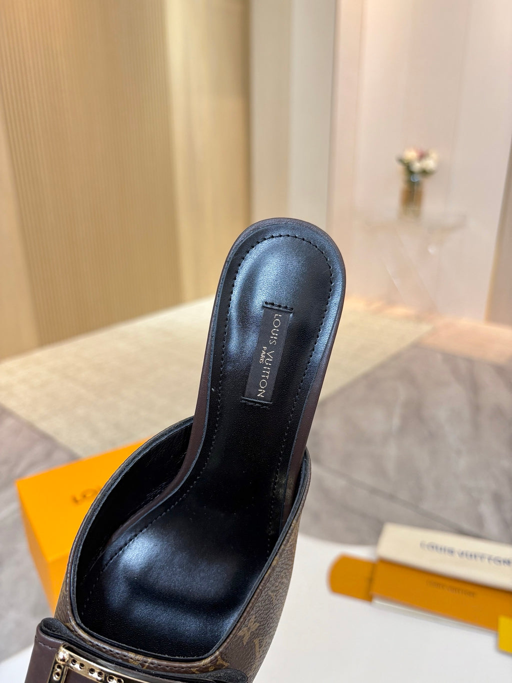Louis Vuitton women's mule shoe, black leather upper with monogram vamp and gold buckle