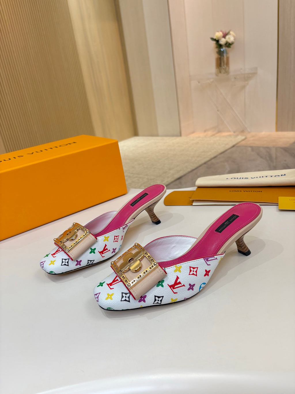 Louis Vuitton ladies mules, multicolor monogram print, gold buckle emblem, pink insoles, low heels
