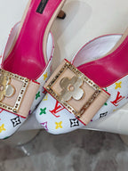 Louis Vuitton ladies mule close-up, gold clover buckle, multicolor monogram strap, pink lining