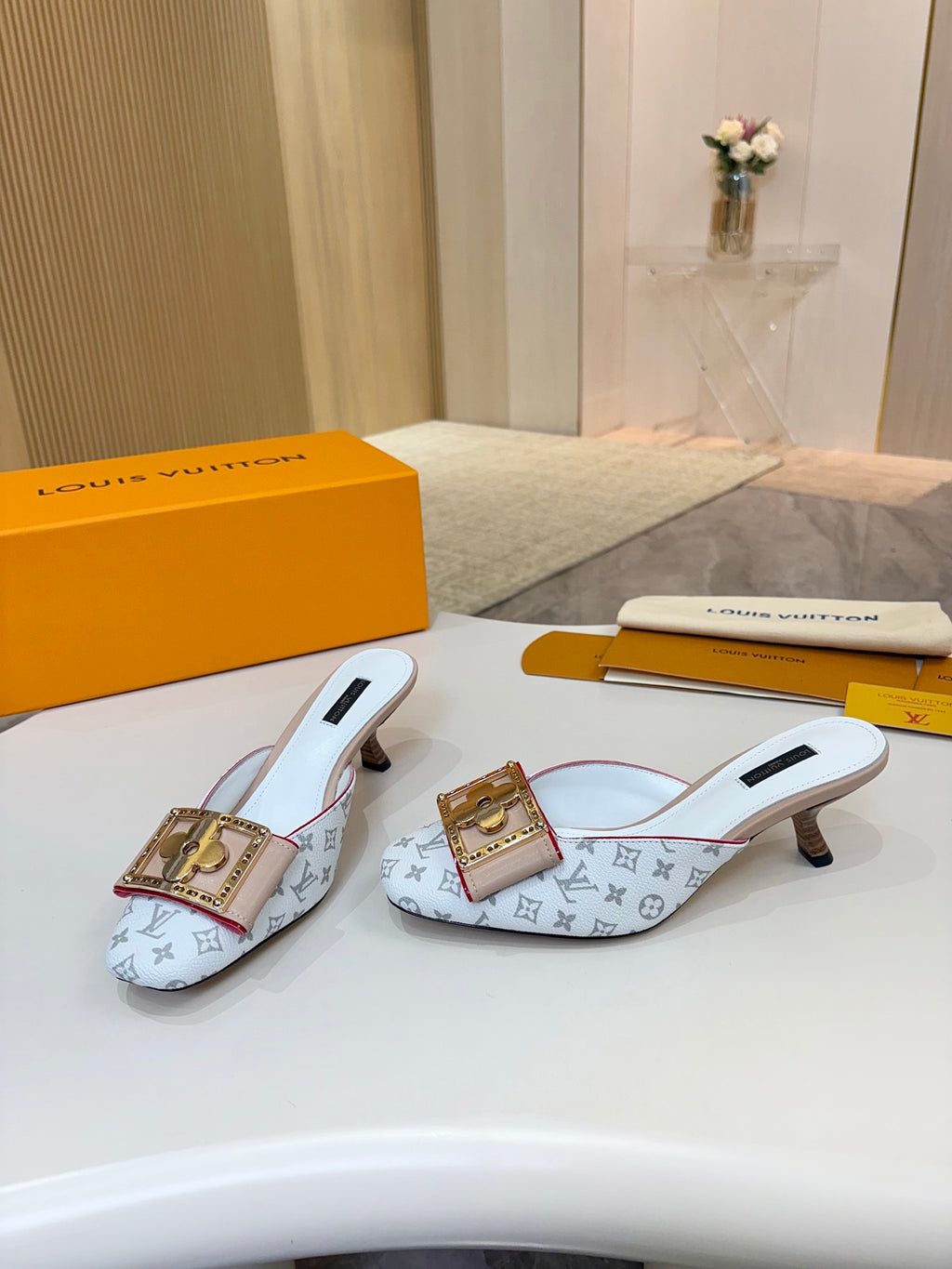 Louis Vuitton monogram slide mules with gold buckles and light blue uppers