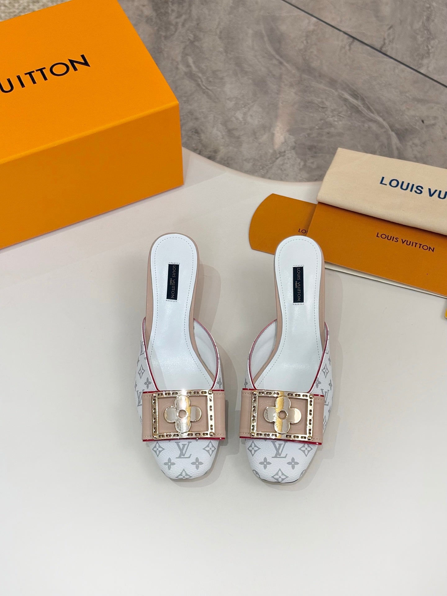 Louis Vuitton light blue slide mules with gold buckles and tan soles