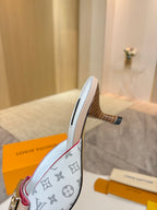 Louis Vuitton monogram mule with light blue upper, gold buckle, and block heel