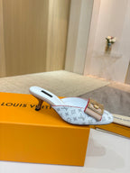 Louis Vuitton monogram slip-on mule in light blue with gold buckle detail