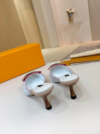 Pair of Louis Vuitton light blue monogram mules with gold buckles and heels